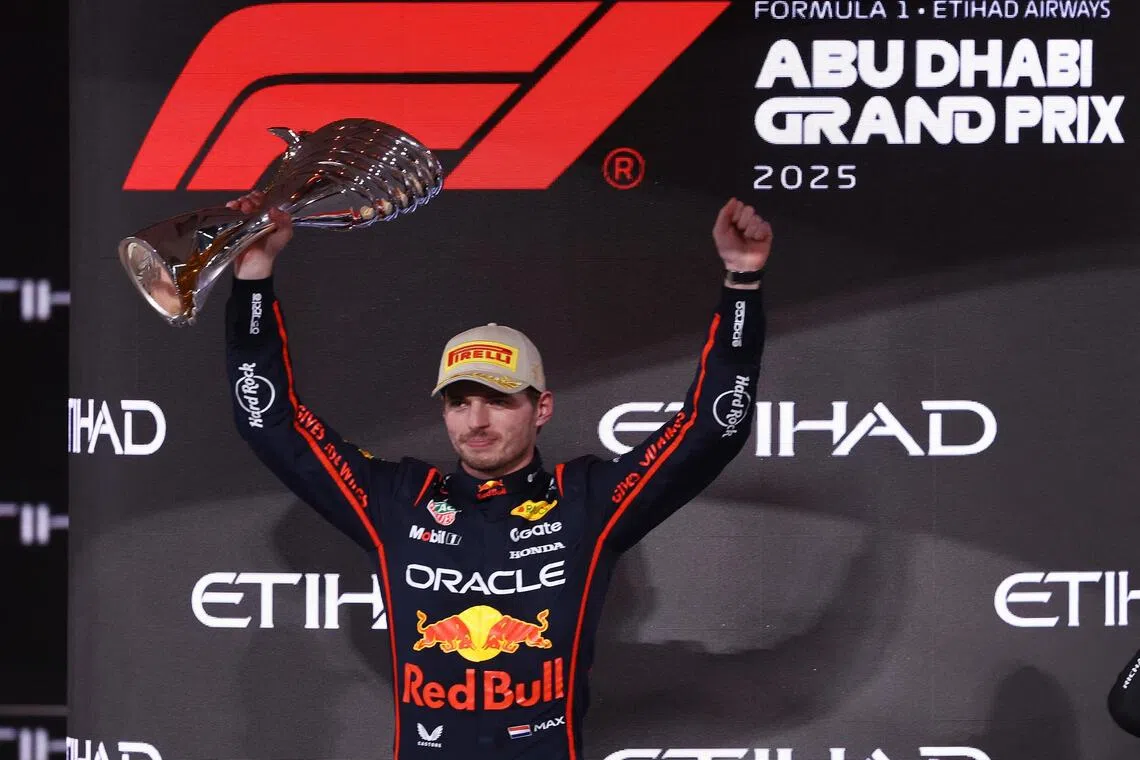 Red Bull's Max Verstappen celebrates on the podium after winning the Abu Dhabi Grand Prix.