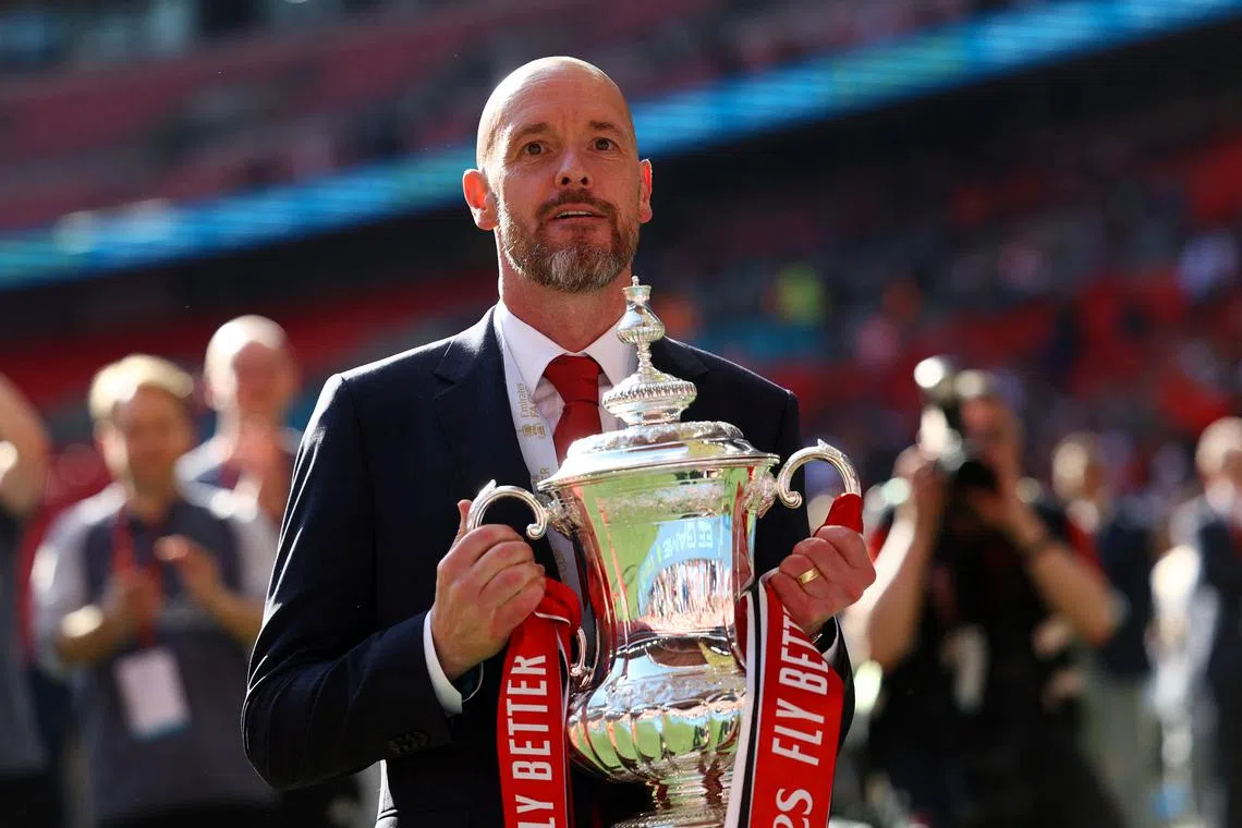 FILE PHOTO: Soccer Football - FA Cup - Final - Manchester City v Manchester United - Wembley Stadium, London, Britain - May 25, 2024 Manchester United manager Erik ten Hag celebrates with the trophy after winning the FA Cup REUTERS/Hannah Mckay/File Photo