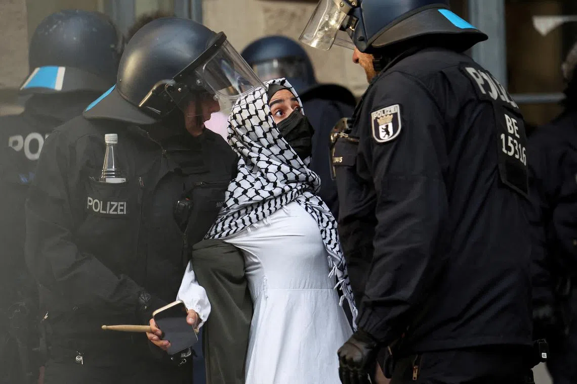 Police officers removing a pro-Palestinian demonstrator, as demonstrators occupy a building at the Humboldt University, amid the ongoing conflict between Israel and Palestinian Islamist group Hamas, in Berlin, Germany, on May 23, 2024. 