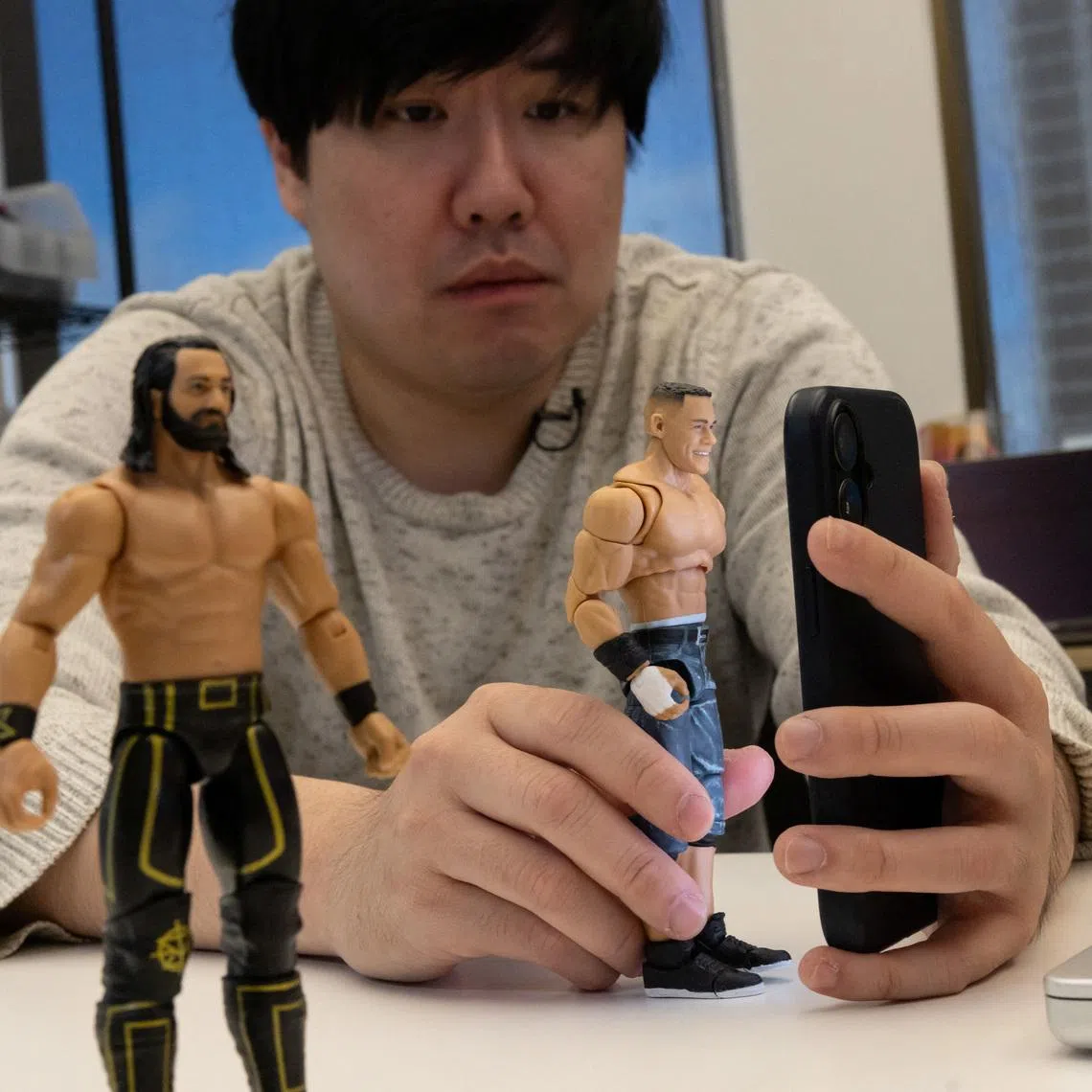 Persona CEO Rick Song holds a plastic toy as he tests an identity verification software at the company’s testing laboratory in San Francisco, California, U.S., March 4, 2026. REUTERS/Carlos Barria