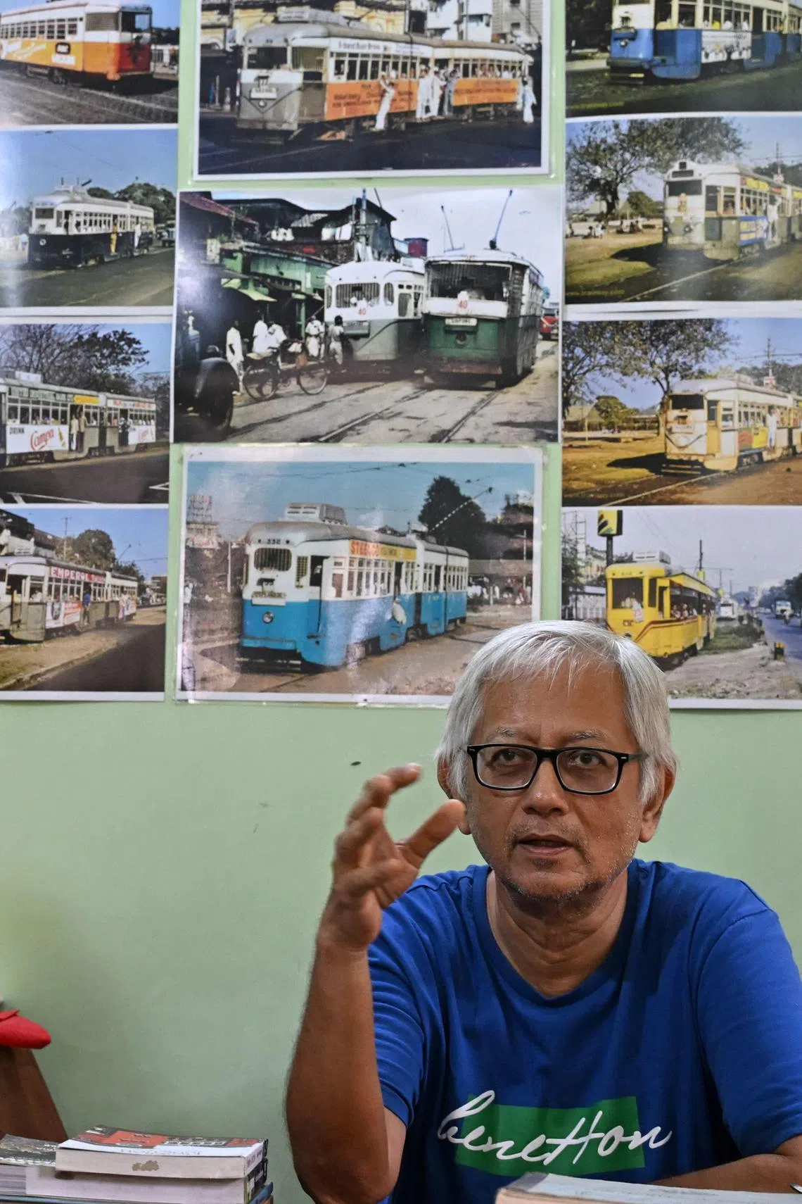 In this photo taken on September 8, 2024, Debashish Bhattacharyya, president of Calcutta Tram Users’ Association (CTUA) speaks during an interview with AFP at his office in Kolkata. Introduced in the sprawling eastern city in 1873 during the early days of the imperial British Raj, trams in Kolkata were initially horse-drawn, then steam-driven. Electric-powered trams took to the streets in 1900. The single-storey trams -- painted in uniform stripes of bright blue and white, with a sunshine yellow top -- trundle at best at around 20 kilometres (12 miles) per hour, if not snarled in traffic blocking its route. (Photo by Dibyangshu SARKAR / AFP) / To go with “Asia’s oldest operating trams see slow death in India” FOCUS