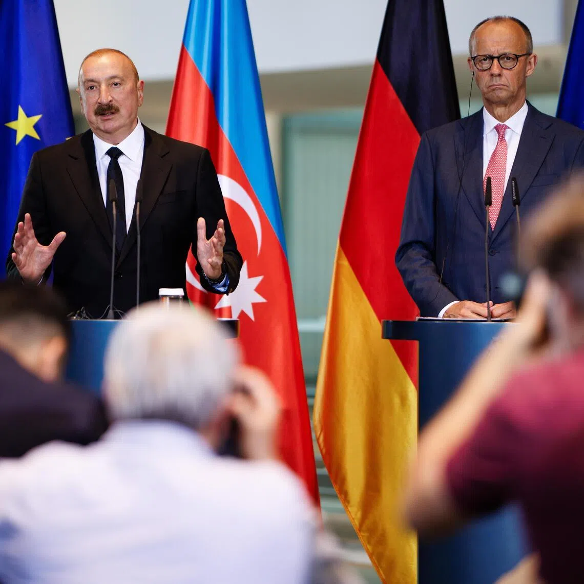 Azerbaijani President Ilham Aliyev (left) gesturing next to German Chancellor Friedrich Merz during a July 21 press conference in Berlin. Aliyev confirmed clandestine meetings took place in his country between Russian and German officials.