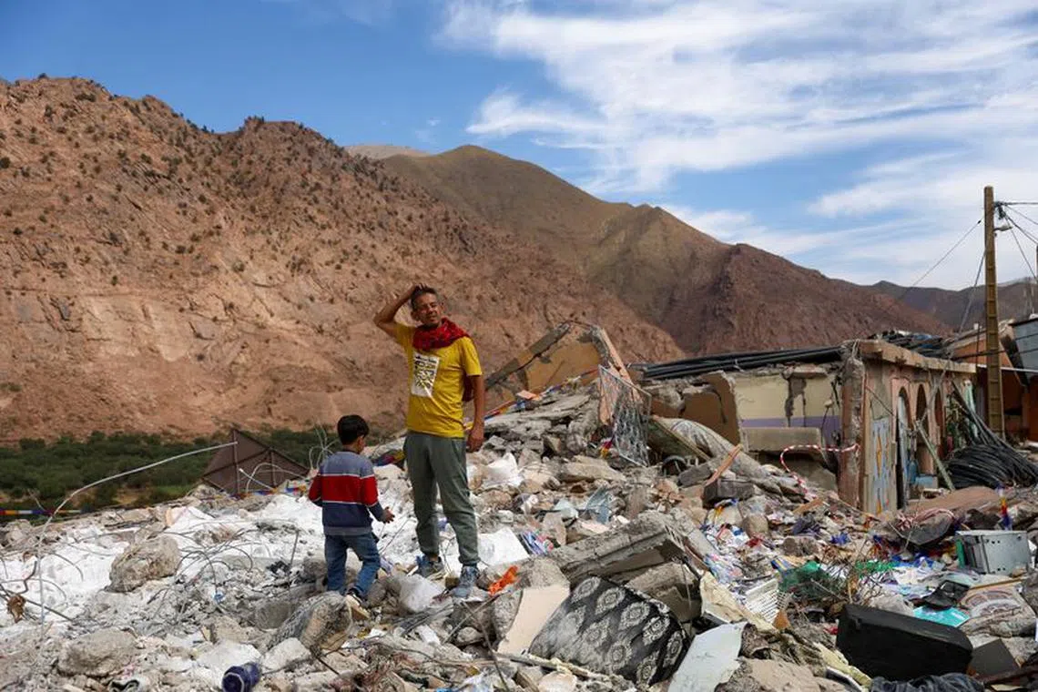Jamal Rbaki, 36, who lost both his parents in the earthquake, stands amongst the rubble of where their house once stood, in the aftermath of a deadly earthquake in Talat N'Yaaqoub, in Morocco September 12, 2023. REUTERS/Hannah McKay