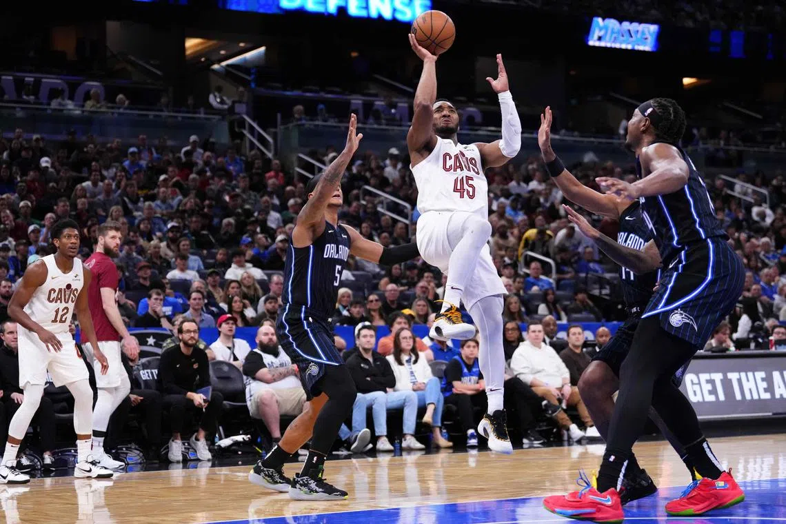 Donovan Mitchell of the Cleveland Cavaliers goes up for a shot against Paolo Banchero of the Orlando Magic during the third quarter at Kia Centre.