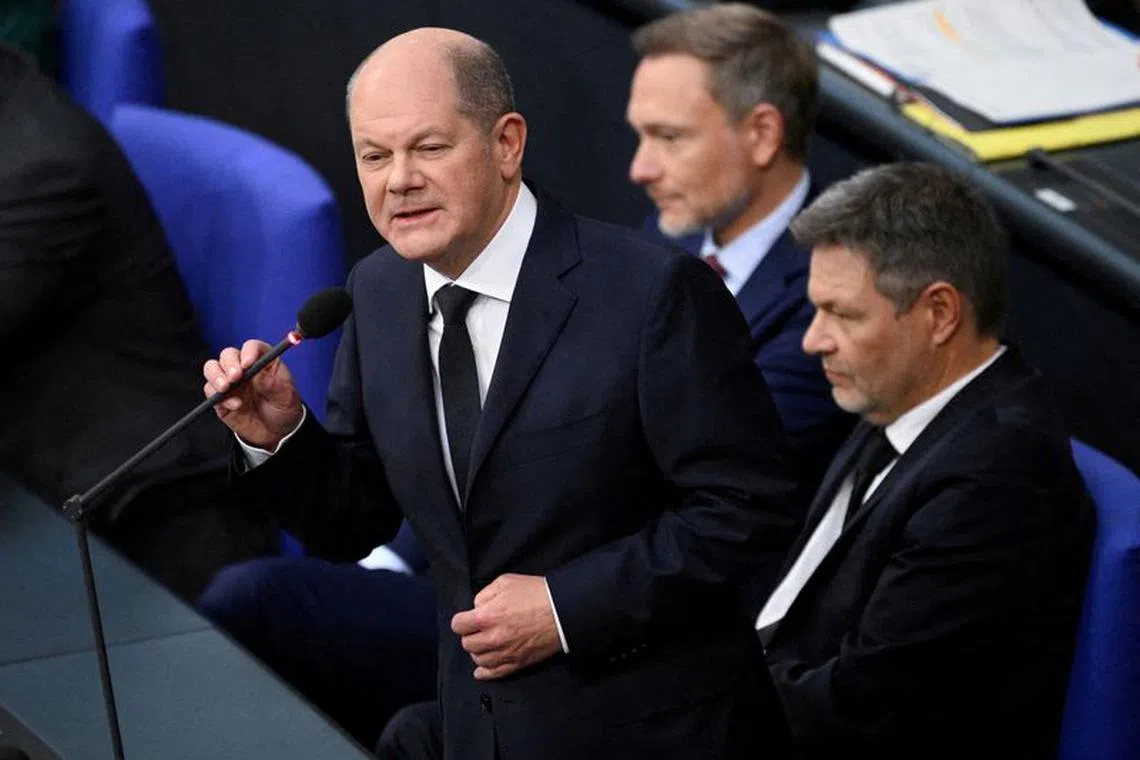 FILE PHOTO: Chancellor Olaf Scholz speaks next to Finance Minister Christian Lindner and Economy and Climate Minister Robert Habeck during a hearing at Germany’s lower house of parliament Bundestag in Berlin, Germany, November 15, 2023. REUTERS/Annegret Hilse/File Photo