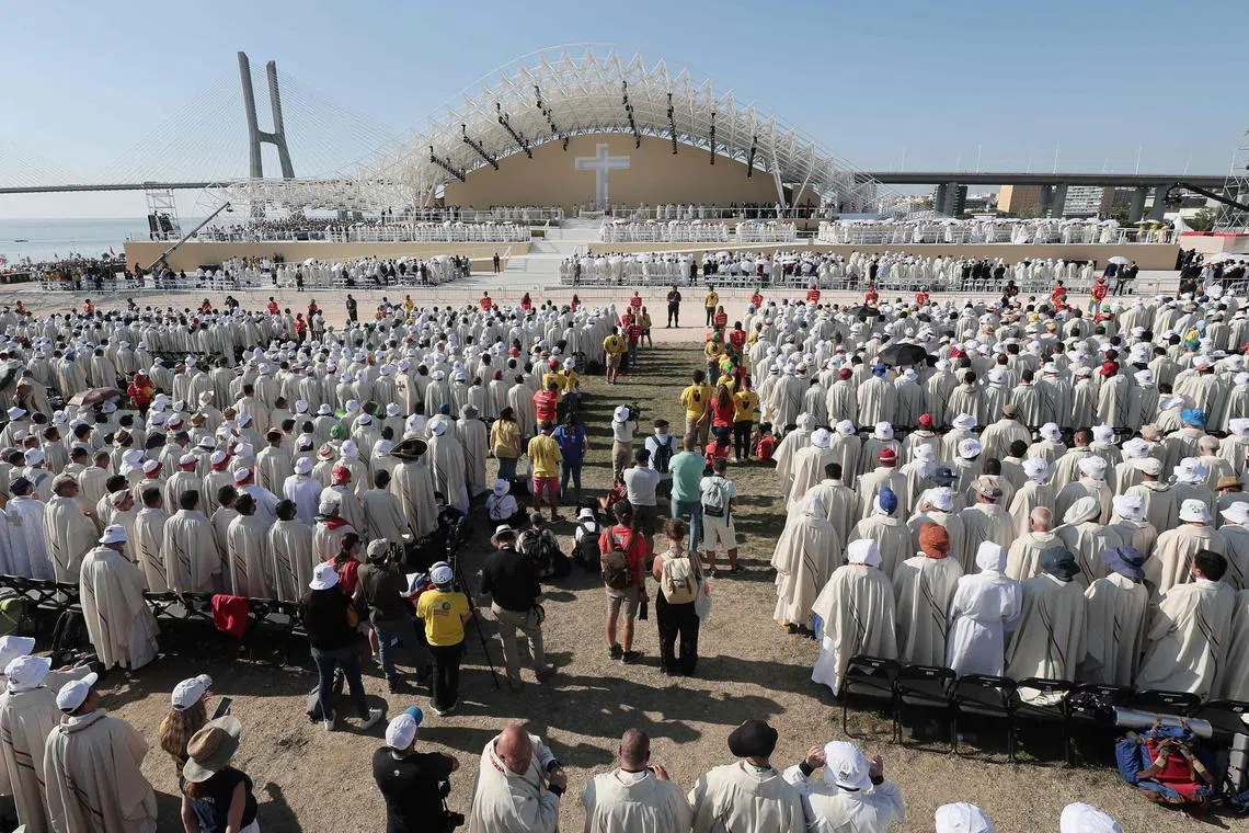 Priests attend the closing mass of the World Youth Days (WYD) in Tejo Park, Lisbon, on August 6, 2023. Around one million pilgrims from all over the world will attend the World Youth Day, the largest Catholic gathering in the world, created in 1986 by John Paul II. (Photo by Thomas COEX / AFP)