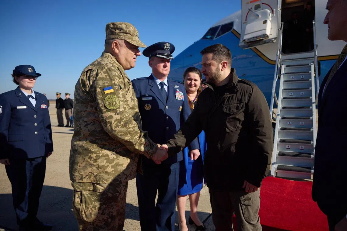 Ukrainian President Volodymyr Zelensky (right) is greeted upon his arrival at Joint Base Andrews,  outside Washington, on Dec 21, 2022.