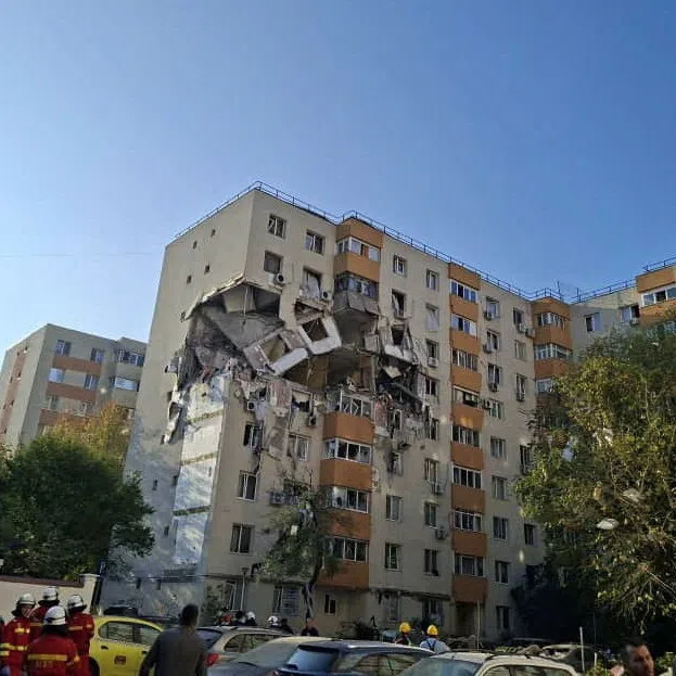 People look at the damage caused by an explosion at an apartment block, in Bucharest, Romania, October 17, 2025. Romanian Emergency Services/Handout via REUTERS ATTENTION EDITORS - THIS IMAGE WAS PROVIDED BY A THIRD PARTY. NO RESALES. NO ARCHIVES. BEST QUALITY AVAILABLE