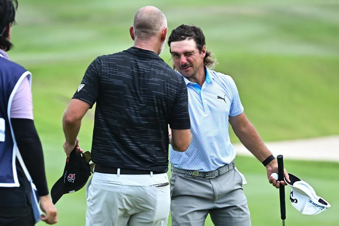 David Micheluzzi (right) holds a one-shot lead after 54 holes at the March 21-24 Porsche Singapore Classic at Laguna National Golf Resort Club.

(ST PHOTO: LIM YAOHUI)