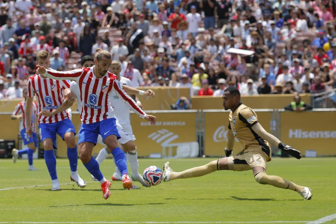Soccer Football - FIFA Club World Cup - Group B - Atletico Madrid v Botafogo - Rose Bowl Stadium, Pasadena, California, U.S. - June 23, 2025  Botafogo's John in action with Atletico Madrid's Antoine Griezmann REUTERS/Mike Blake