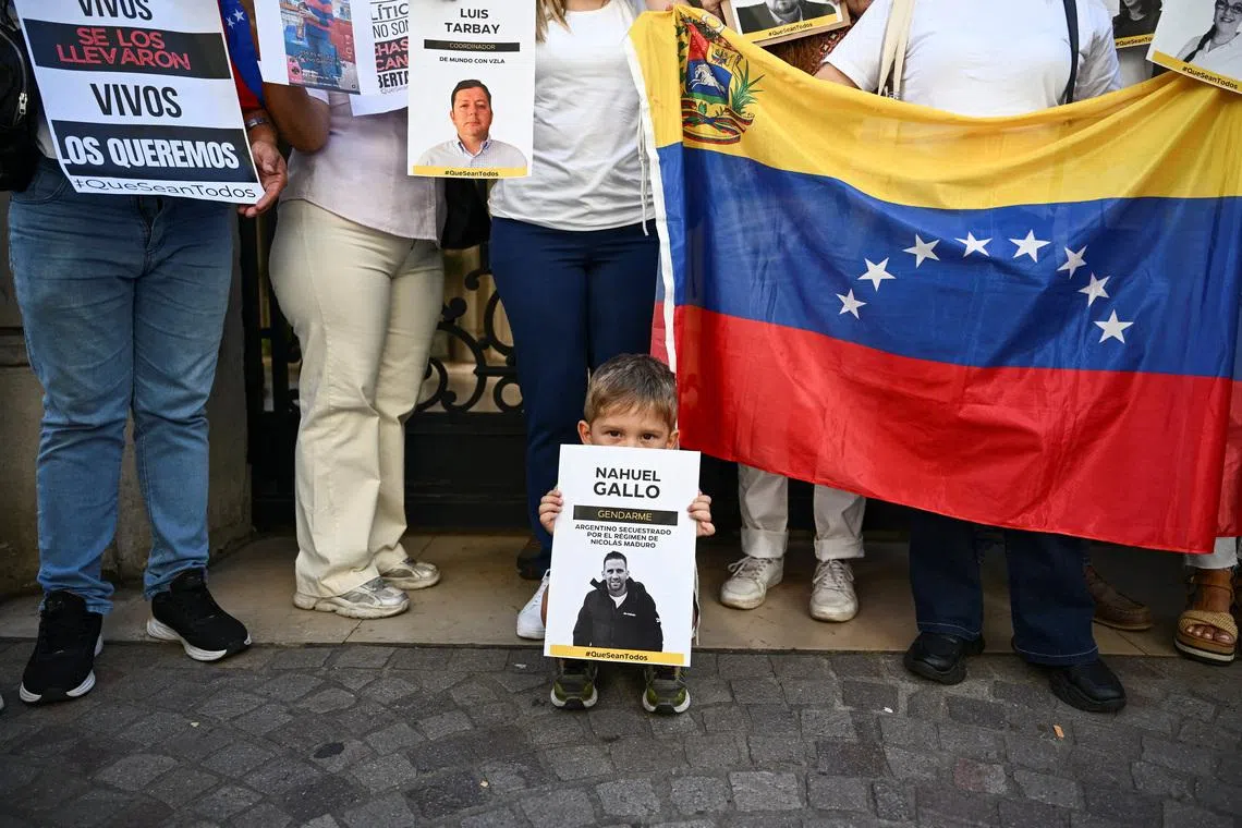 Victor, son of Argentine Gendarmerie officer Nahuel Gallo, detained in Venezuela, holds a poster as he stands with relatives outside the Apostolic Nunciature along with activists to ask the Vatican to press Venezuelan authorities for the detainees' release, in Buenos Aires, Argentina, January 23, 2026. REUTERS/Pedro Lazaro Fernandez