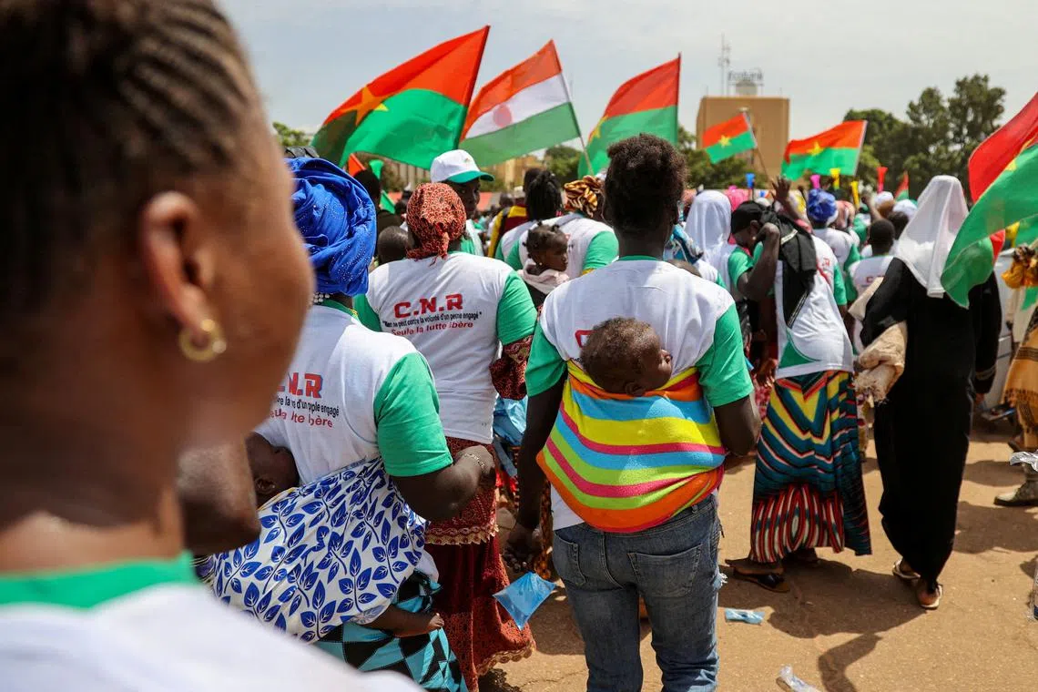 FILE PHOTO: Supporters of Burkina Faso's junta attend a rally to mark the one-year anniversary of the coup that brought Captain Ibrahim Traore to power in Ouagadougou, Burkina Faso September 29, 2023.REUTERS/ Yempabou Ouoba/File Photo