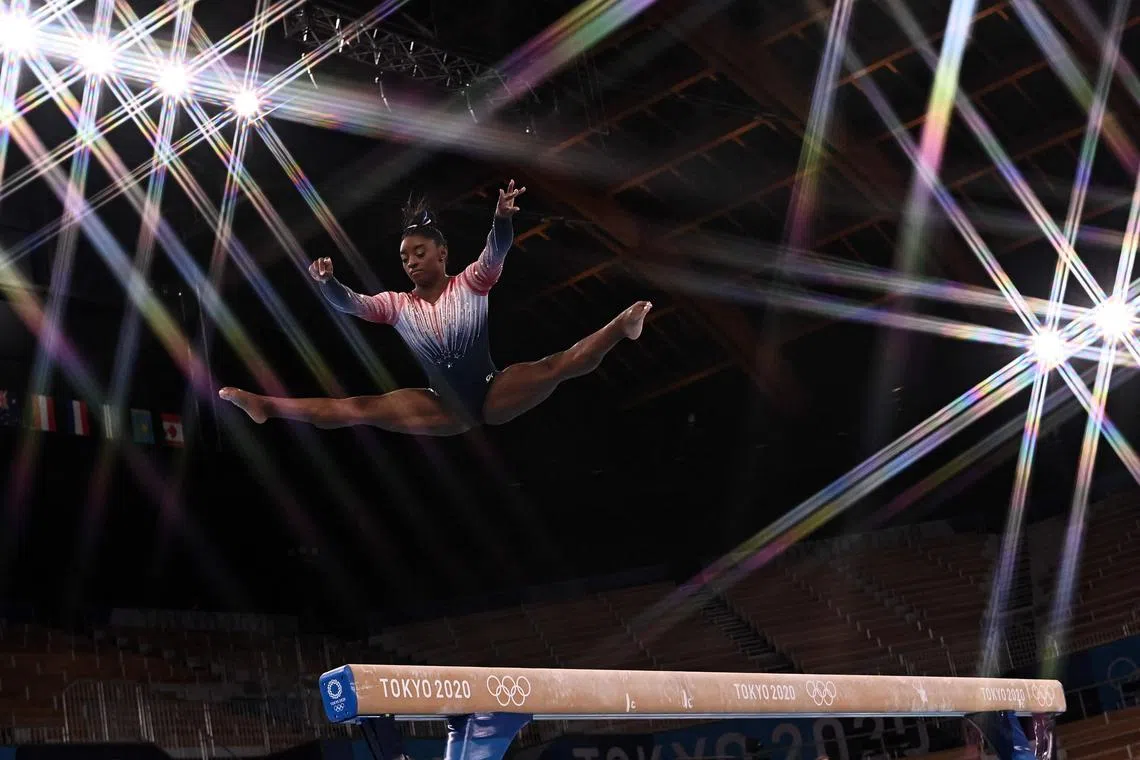 (FILES) USA's Simone Biles practices ahead of the artistic gymnastics women's balance beam final of the Tokyo 2020 Olympic Games at Ariake Gymnastics Centre in Tokyo on August 3, 2021. World gymnastics superstar Simone Biles, who has not competed since the Tokyo Olympics in 2021, makes her return on August 5, 2023 at the US Classic in Chicago, a possible first stop on the road to the Paris Olympics. (Photo by Lionel BONAVENTURE / AFP)