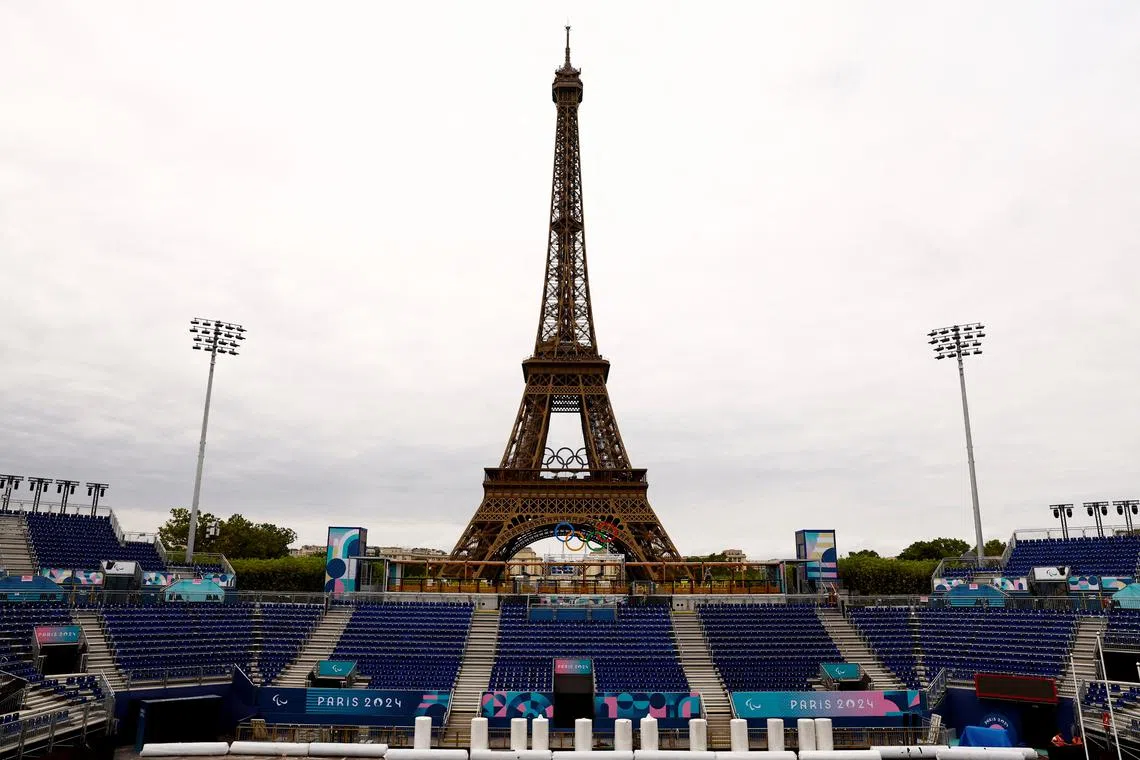 FILE PHOTO: Paris 2024 Paralympics - Paris, France - August 18, 2024  Workers work to convert the Eiffel Tower Stadium from the beach volleyball venue to the Paralympic blind football venue for the coming Paris 2024 Paralympic Games REUTERS/Abdul Saboor/File Photo