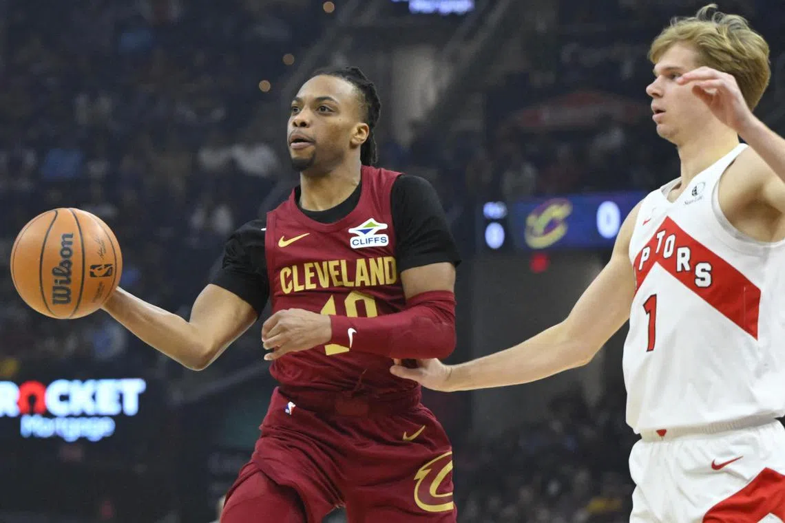 Cleveland Cavaliers guard Darius Garland throws a pass beside Toronto Raptors guard Gradey Dick in the first quarter at Rocket Mortgage FieldHouse.