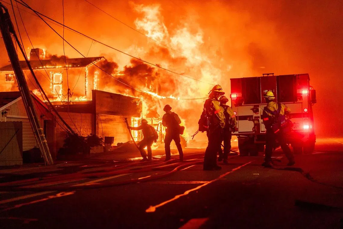 Firefighters battle flames during the Palisades Fire in the Pacific Palisades neighborhood of Los Angeles, California, US, on Tuesday, Jan. 7, 2025. A fast-moving wildfire ripped through an affluent neighborhood in Los Angeles, forcing thousands of people to evacuate as the region braced for a brutal wind storm that could last well into the weekend. Photographer: Kyle Grillot/Bloomberg