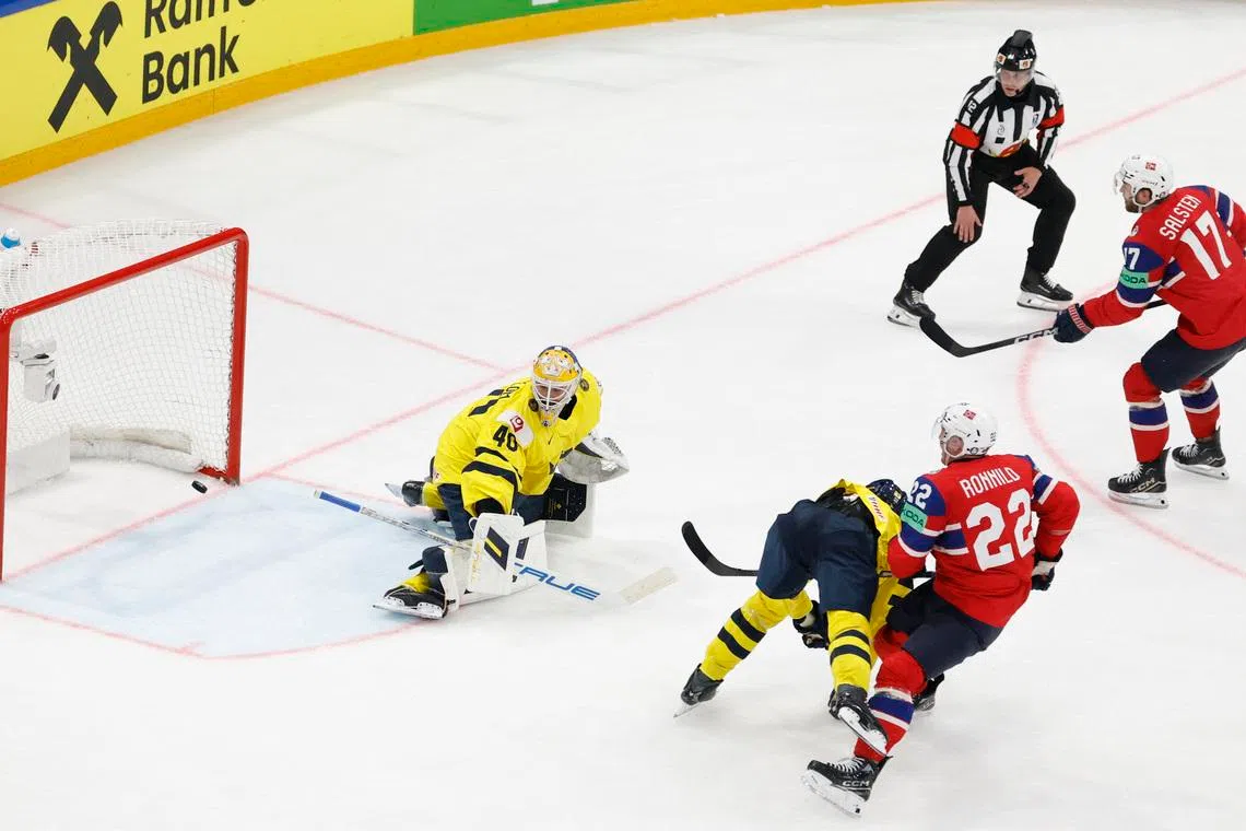 Ice Hockey - IIHF World Championships - Group B - Norway v Sweden - BCF Arena, Fribourg, Switzerland - May 23, 2026 Norway's Eirik Salsten scores their third goal past Sweden's Arvid Soderblom REUTERS/David W Cerny
