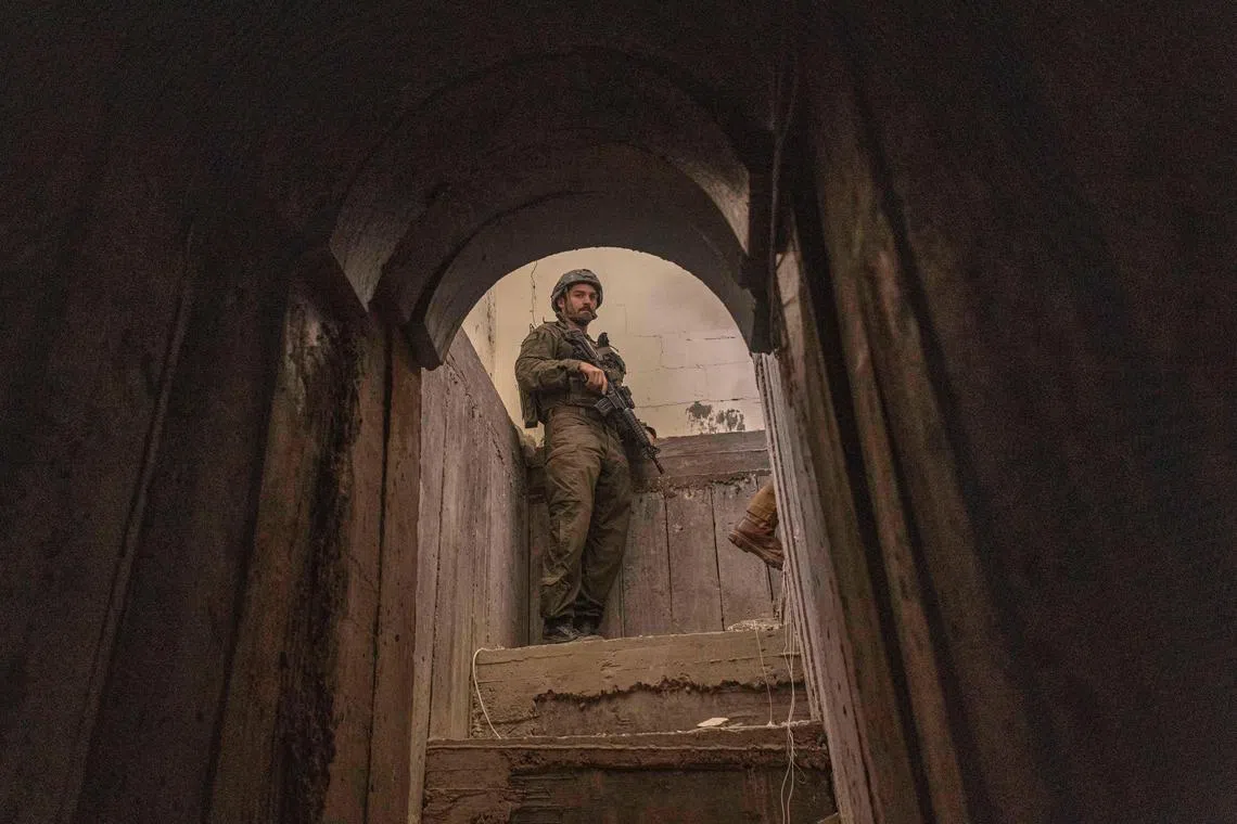 An Israeli soldier standing at the entrance of a tunnel found inside a house in the Central Gaza strip Gaza. Hamas leaders spent years developing an underground warfare plan.