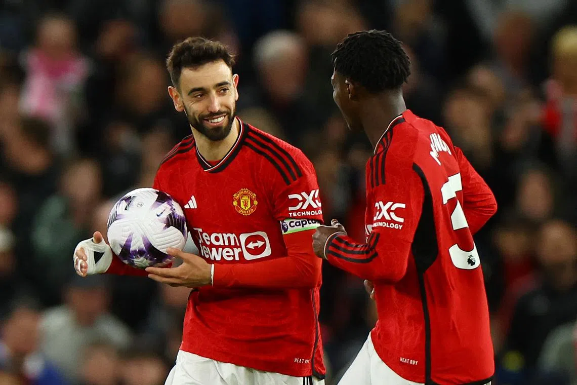 Soccer Football - Premier League - Manchester United v Sheffield United - Old Trafford, Manchester, Britain - April 24, 2024 Manchester United's Bruno Fernandes celebrates scoring their second goal with Kobbie Mainoo REUTERS/Molly Darlington