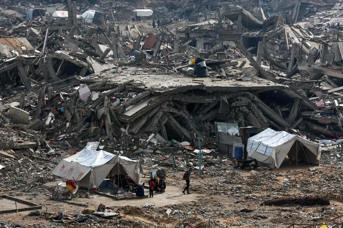 People erecting tents amid the rubble of destroyed buildings, as displaced Palestinians return to the northern areas of the Gaza Strip, in Jabalia, on Jan 23.