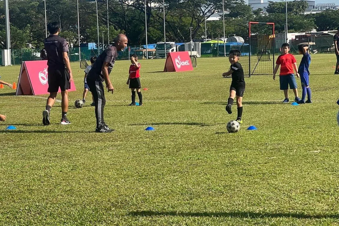 Sports enthusiasts playing sports like football and hockey at the ActiveSG Sport Village@ Jurong Town.

