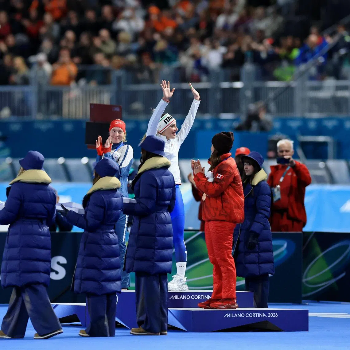 Feb 7, 2026; Milan, Italy; Gold medalist Francesca Lollobrigida of Italy stands on the podium with silver medalist Ragne Wiklund of Norway and bronze medalist Valerie Maltais of Canada during the medal ceremony for the women's speed skating 3000m during the Milano Cortina 2026 Olympic Winter Games at Milano Speed Skating Stadium. Mandatory Credit: Katie Stratman-Imagn Images