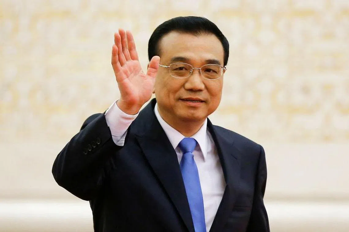 FILE PHOTO: China's Premier Li Keqiang waves as he arrives for a news conference after the closing ceremony of China's National People's Congress (NPC) at the Great Hall of the People in Beijing, China, March 15, 2017. REUTERS/Damir Sagolj/File Photo