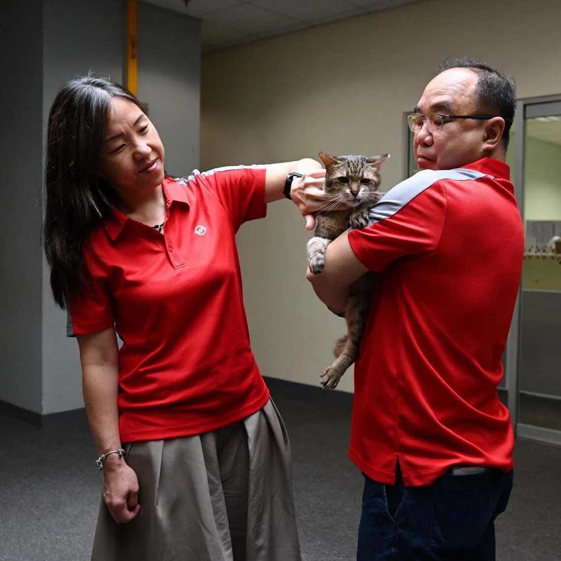 SMRT Trains’ Daniel Siew, 52, engineering maintenance manager, and Zanna Lee, 50, senior manager, plans and resource management, with Cassidy.
