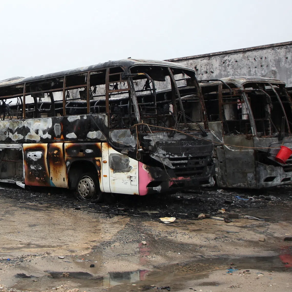 Wrecked buses that were burnt during protests, following a general election marred by violent demonstrations over the exclusion of two leading opposition candidates, stand at the Mwembechai area in Kinondoni district in Dar es Salaam, Tanzania November 4, 2025. REUTERS/Emmanuel Herman