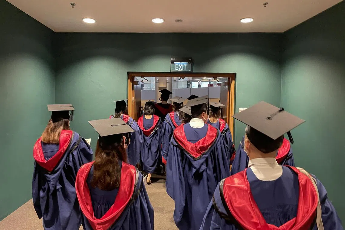 pixgeneric/Shintaro Tay/ Graduating students from Nanyang Technological University (NTU) leaving the auditorium after a convocation ceremony on July 22, 2022. Keywords: university education, graduation, students, tertiary institutions.