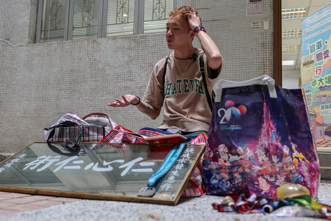 Dorz Cheung, a resident of Wang Fuk Court, shows family belongings, which he retrieved from his flat during his first return visit home since a deadly fire last year, in Hong Kong, China, April 21, 2026. REUTERS/Tyrone Siu