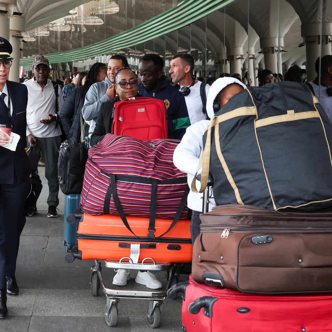 An airline official walks as travellers queue and wait to be processed to travel after Kenya aviation workers ended their strike that disrupted flights at the Jomo Kenyatta International Airport (JKIA) in Nairobi, Kenya, September 1, 2026. REUTERS/Monicah Mwangi
