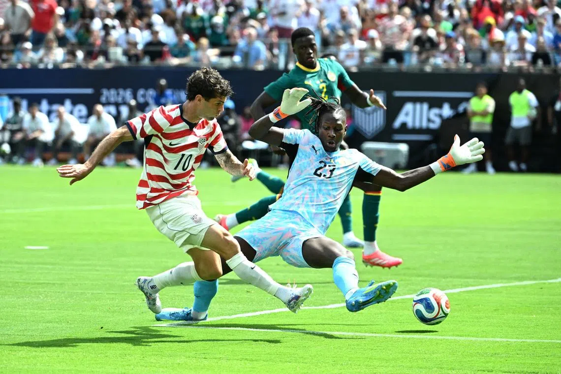 US talisman Christian Pulisic scoring past Senegal goalkeeper Edouard Mendy during the Americans' 3-2 friendly win on May 31.