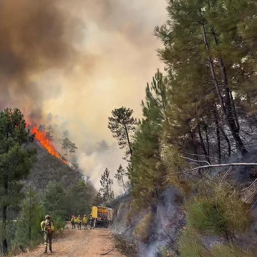 An Aug 19 video still shows firefighters tackling a wildfire near El Cerezal, in Spain’s western region of Extremadura.