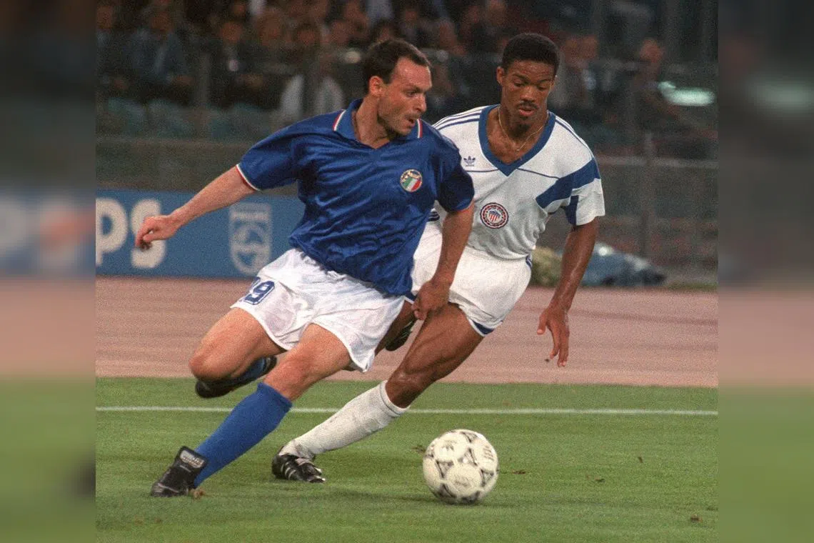 Italy striker Salvatore Schillaci (left) tries to control the ball under pressure from US defender Jimmy Banks in a group match during the 1990 World Cup.