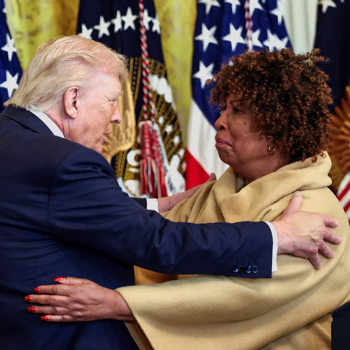 US President Donald Trump embraces Ms Forlesia Cook, a grandmother who lost her grandson to violence, during a Black History Month reception on Feb 18.