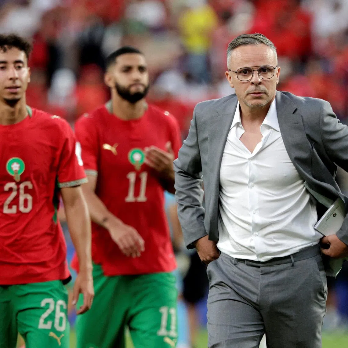 Soccer Football - FIFA World Cup 2026 - Group C - Brazil v Morocco - New York/New Jersey Stadium, East Rutherford, New Jersey, U.S. - June 13, 2026 Morocco coach Mohamed Ouahbi with their players after the match  REUTERS/Jeenah Moon REFILE - CORRECTING EVENT