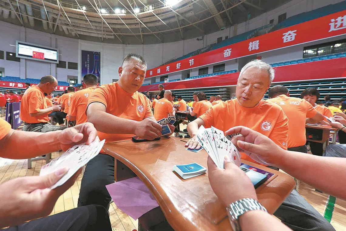 Players compete in a guandan competition in Huaian, Jiangsu province. 