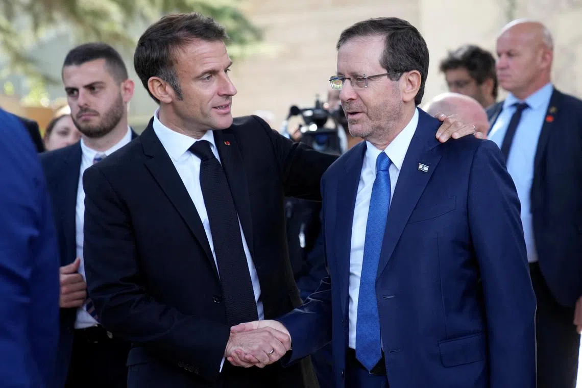 Mr Macron (L) told President Isaac Herzog that the first objective should be to free hostages in Gaza.
