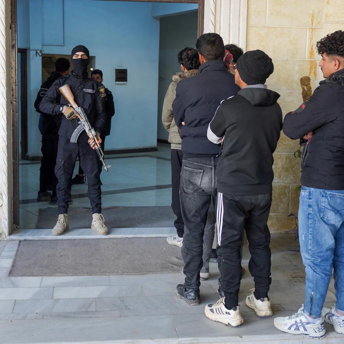 Members of the Kurdish-led Syrian Democratic Forces (SDF) queue to settle their status with Syrian government in Raqqa, Syria January 27, 2026. REUTERS/Karam al-Masri