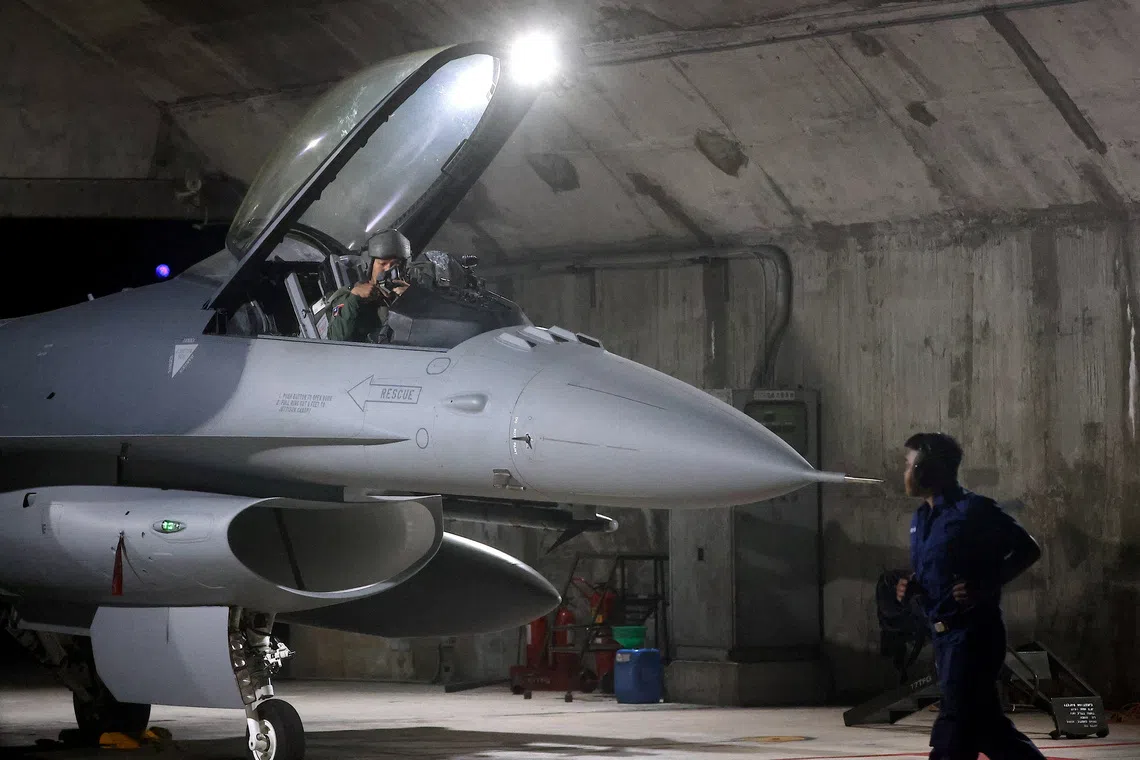 An Air Force soldier runs next to F-16V fighter jet as the pilot prepares for an evening take off as part of a combat readiness mission at the airbase in Hualien, Taiwan, August 17, 2022. REUTERS/Ann Wang