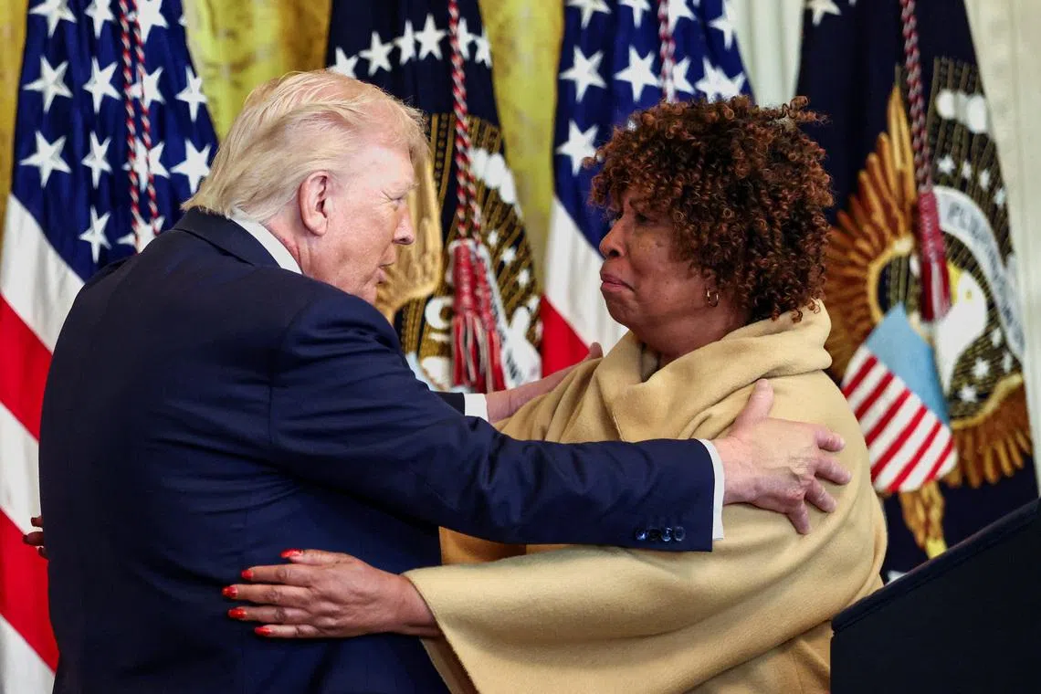 US President Donald Trump embraces Ms Forlesia Cook, a grandmother who lost her grandson to violence, during a Black History Month reception on Feb 18.