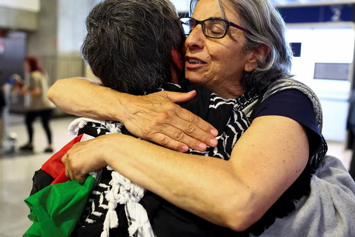 French activists from the Gaza-bound Global Sumud Flotilla, detained by Israeli forces after their vessels were intercepted in international waters in the Mediterranean, arrive at Charles de Gaulle Airport, in Roissy-en-France, near Paris, France May 22, 2026. REUTERS/Abdul Saboor