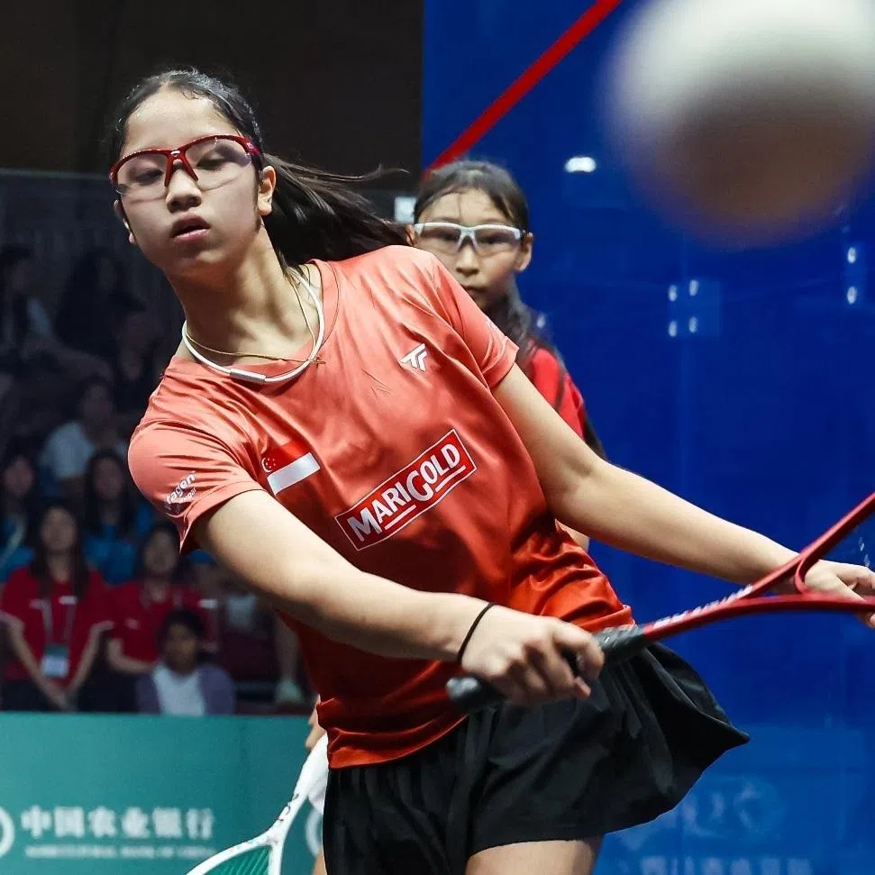 Singapore's Kareena Sashikumar (front) smashing her way to a 11-2, 11-3, 11-1 win over Japan's Rio Yoshino in the U-13 girls' final of squash's Asian Junior Individual Championships.