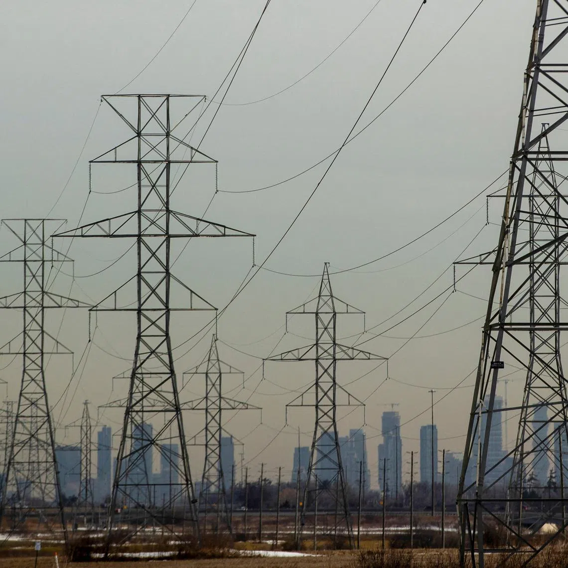 FILE PHOTO: Power lines stretch towards the city of Mississauga visible in the background in Oakville, Ontario, Canada, March 13, 2025. REUTERS/Carlos Osorio/File Photo