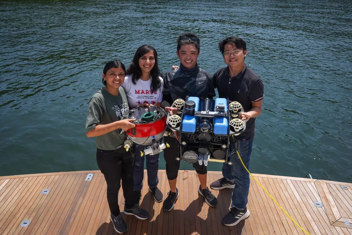 Dr Malika Meghjani (second from left) with her team members (from left) research assistant Shrutika Vishal Thengane, hardware engineer Hoo Jun Jie, and Master’s student Marcel Bartholomeus Prasetyo and their underwater robot on Sep 25.