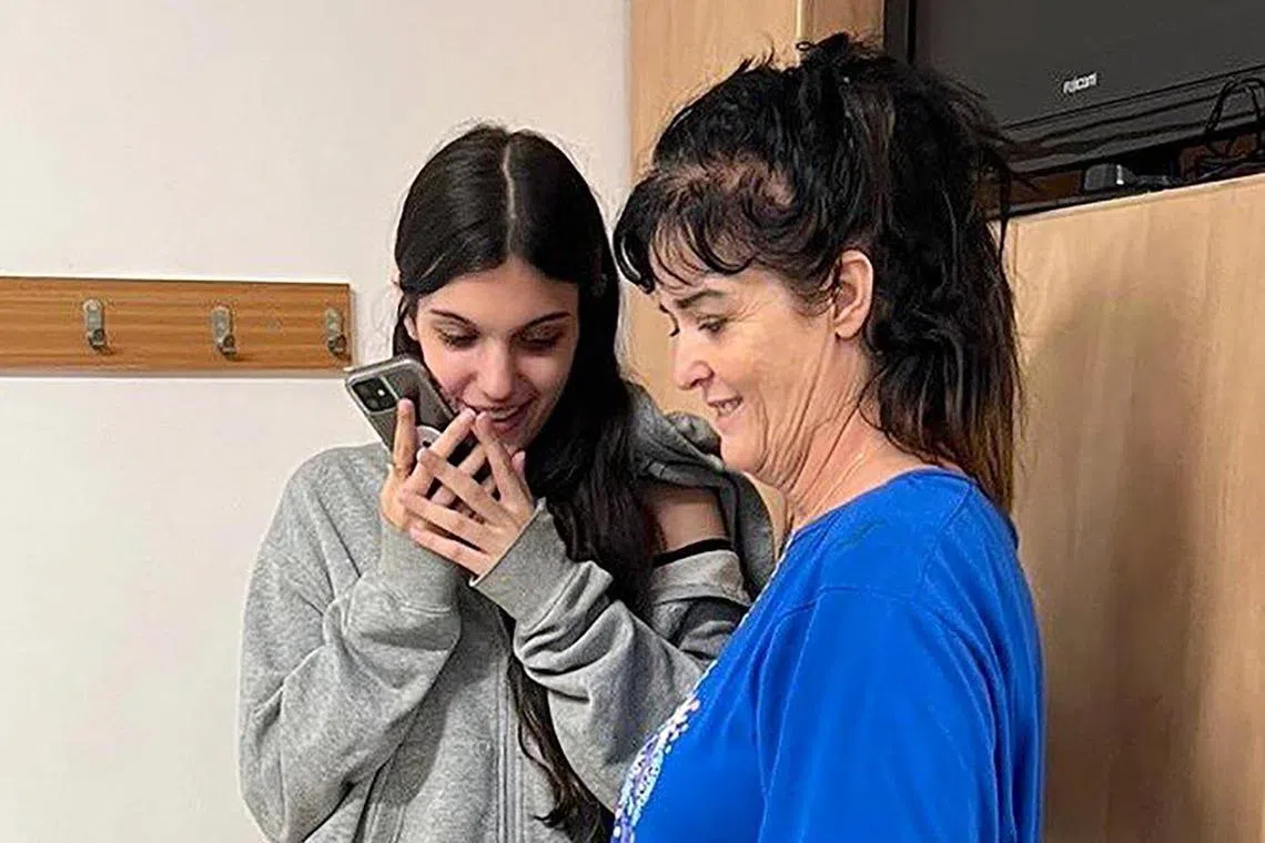 Natalie Raanan (left) and her mother Judith speak with US President Joe Biden on the phone after being released from captivity, at the US Embassy in Jerusalem on Oct 20.