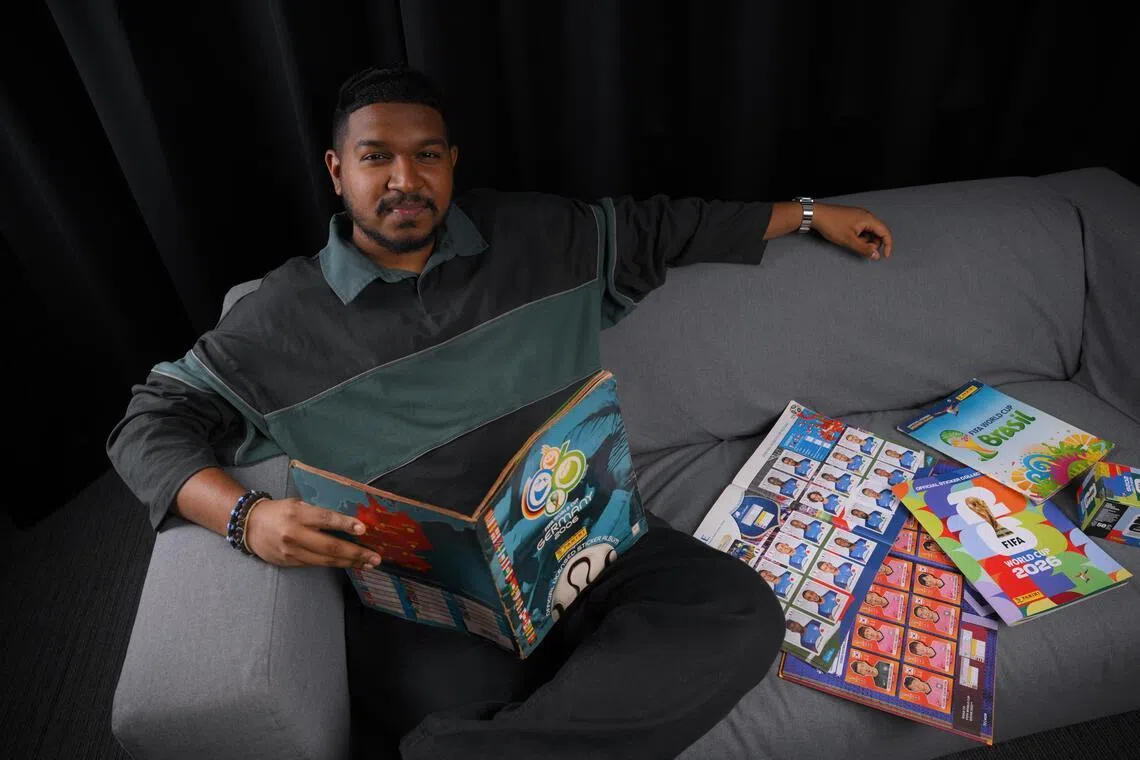 The Straits Times sports journalist Deepanraj Ganesan with his World Cup Panini sticker book collection.
