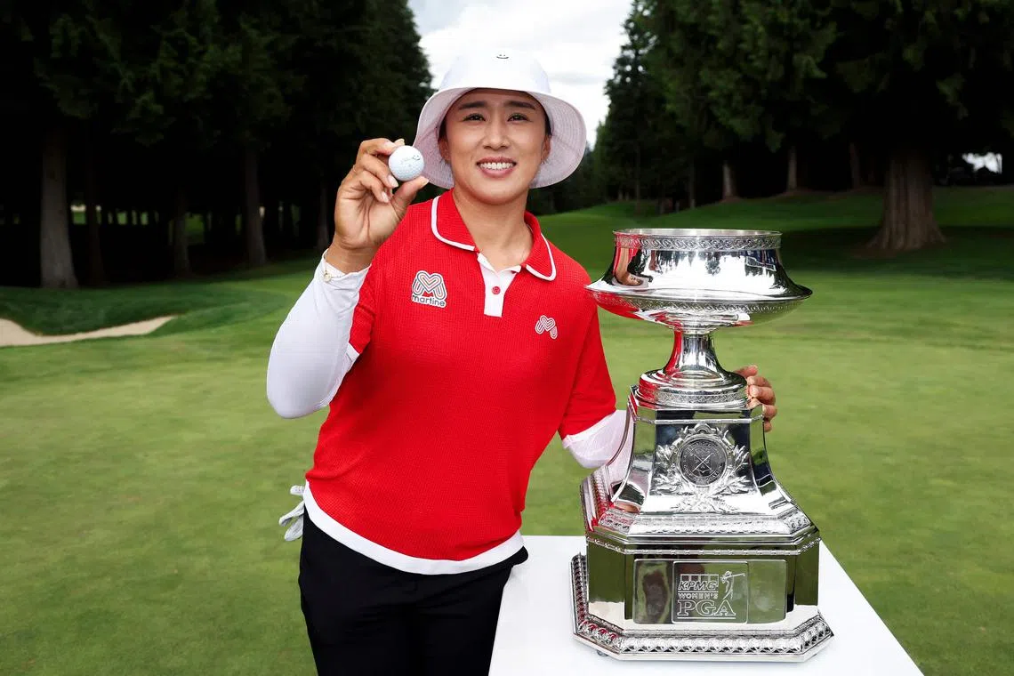 Amy Yang of South Korea posing with her Titleist golf ball and the trophy after winning the Women's PGA Championship at Sahalee Country Club.