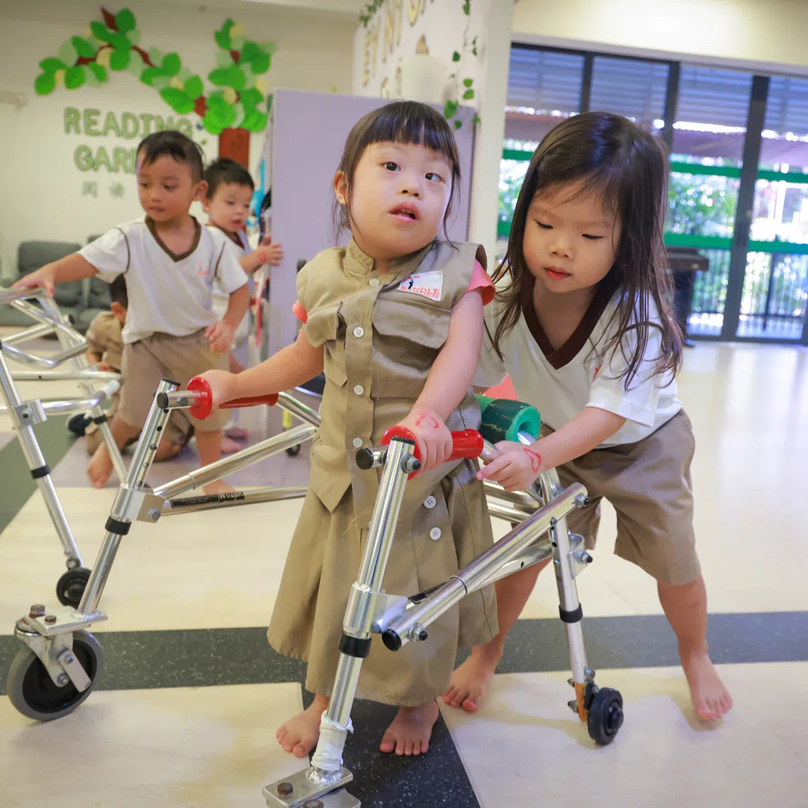 ST20260824_202631400749_jqkindle_Jason Quah

Liv Heng (right), three, helping classmate Anna Kham, three, who has down syndrome, with her walker as they head for lunch at Kindle Garden inclusive pre-school. At Kindle Garden it is second nature for typically-developing children to help their friends with additional needs without being prompted by teachers. Pictured 24 Aug, 2026.